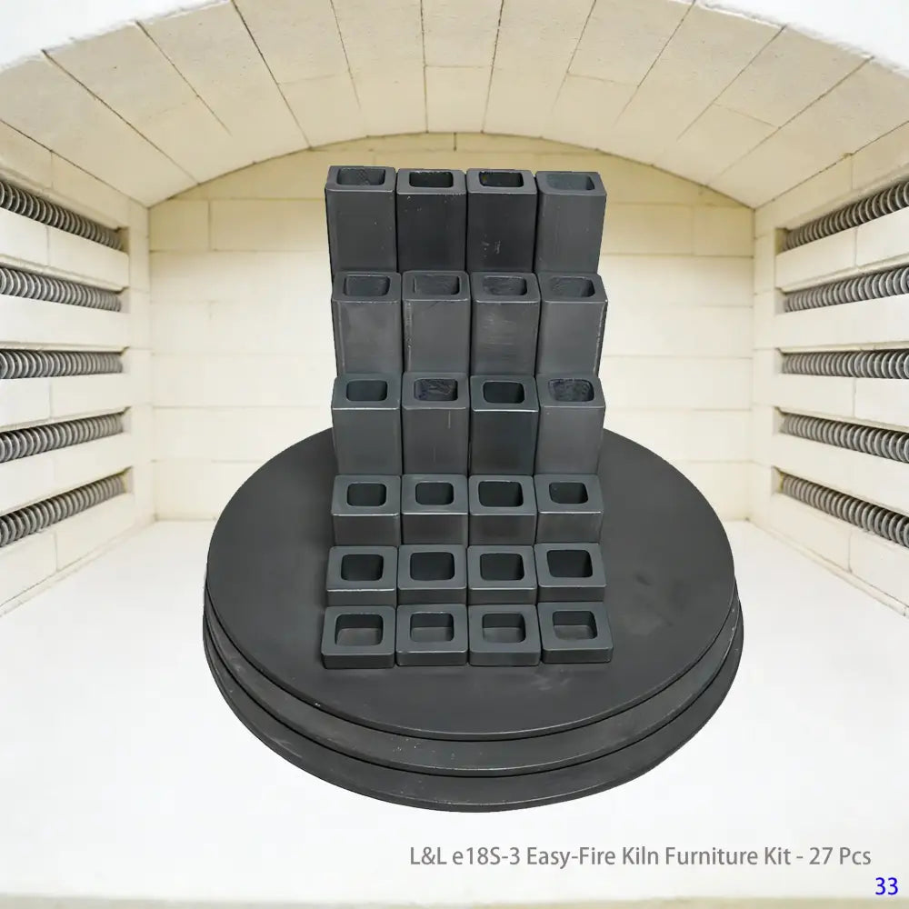A 27-piece L&L e18S-3 Easy-Fire kiln accessory set arranged neatly, featuring kiln posts and shelves, designed for organized stack-firing in ceramic and pottery kilns.
