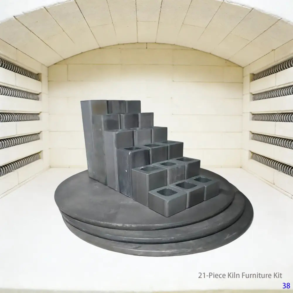 An image showing a 21-piece kiln furniture kit designed for the Skutt 714 model kiln. The set includes refractory kiln shelves, posts, and stilts, neatly arranged on a workbench, serving as essential accessories for ceramic firing.
