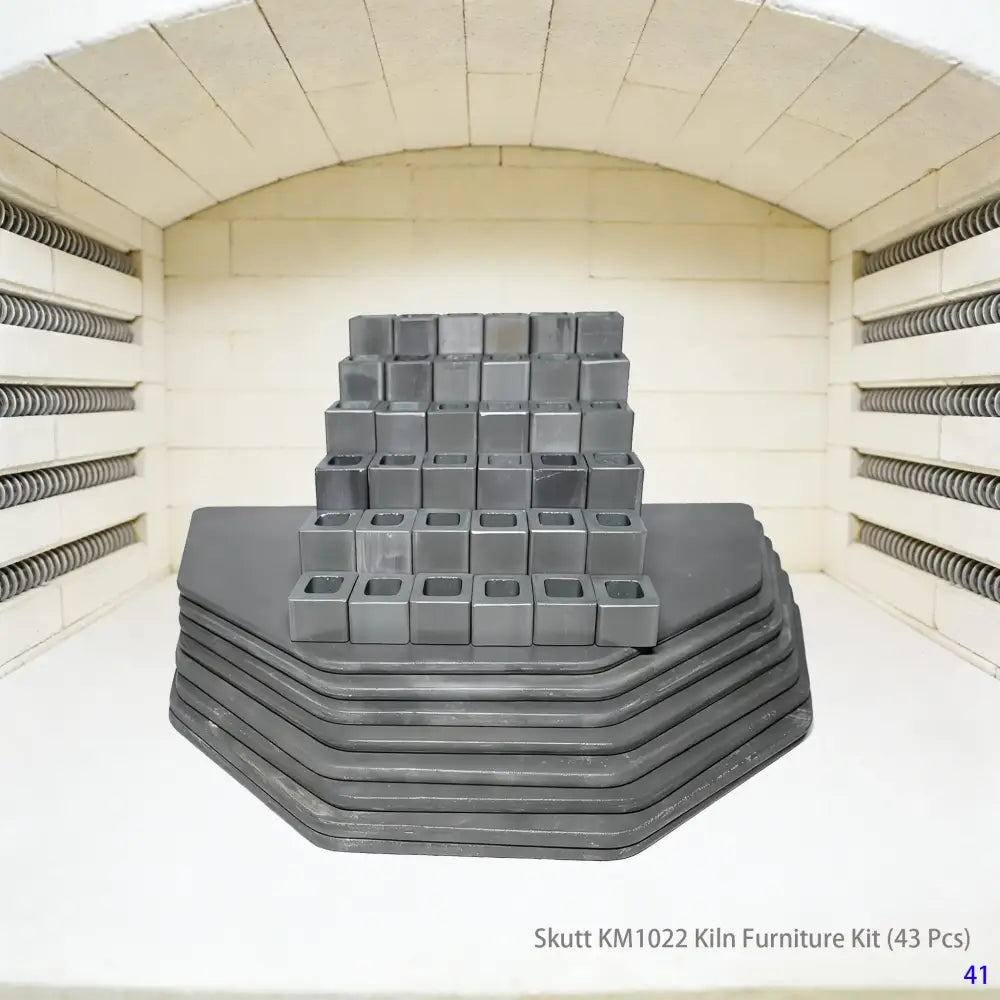 A complete 43-piece high-temperature kiln furniture set designed for Skutt KM1022 electric kilns. The set includes various sizes of square and round refractory shelves, alumina posts in different heights, and triangular support stilts, meeting the professional ceramic firing needs of pottery studios.